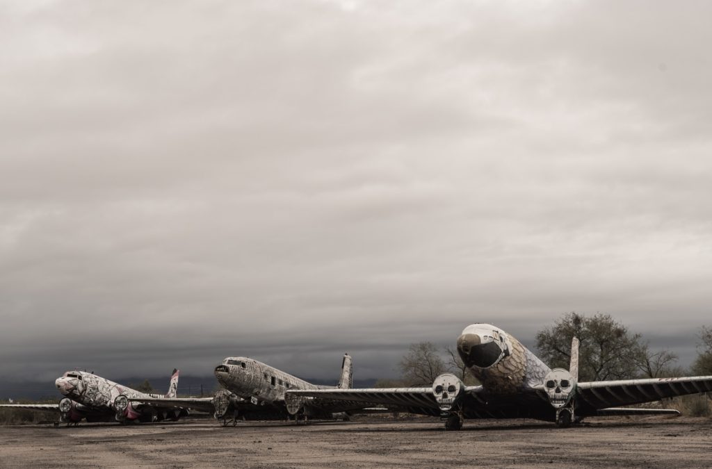 Three abandoned aeroplanes covered with illustrative art. Do they feel flygskam too?